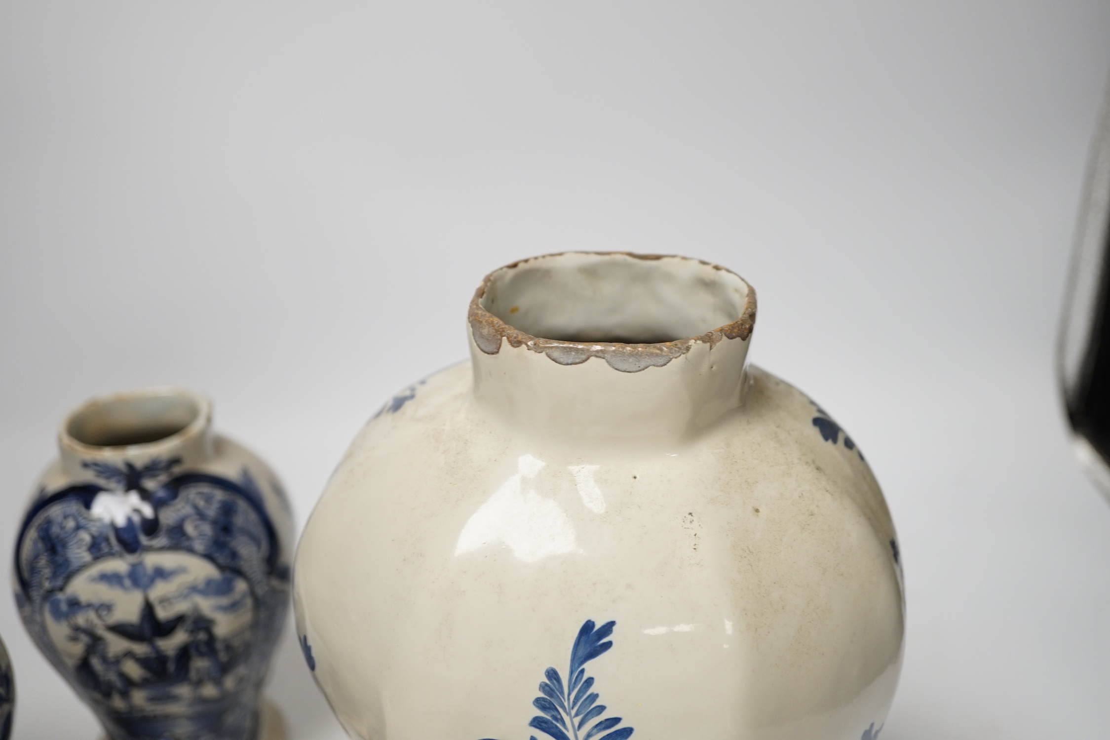 An 18th century Delft blue and white vase and a pair of later Delft vases and covers, tallest 23.5cm